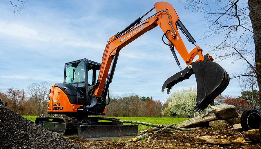 Hitachi compact excavator on a construction site.