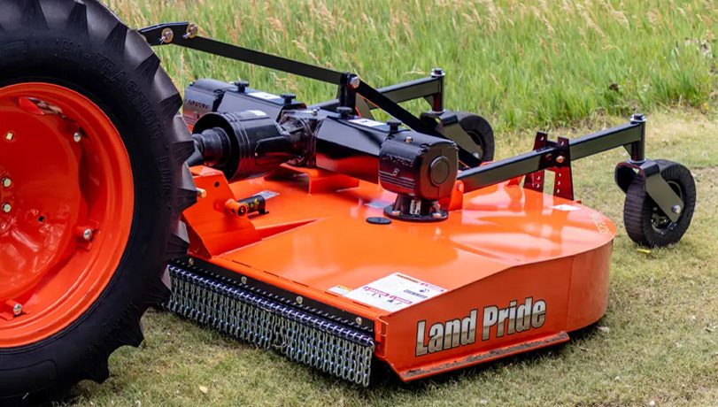 New Land Pride RCF3096 Series Rotary Cutters mounted behind a tractor cutting grass in a field.