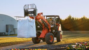 Person moving landscaping supplies using a Kubota R540 Wheel Loader.