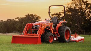 Kubota L3560HSTC-LE Tractor with a Land Pride attachment in a field at sunset.
