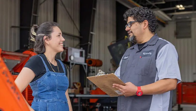 Kubota service tech talking with a customer.